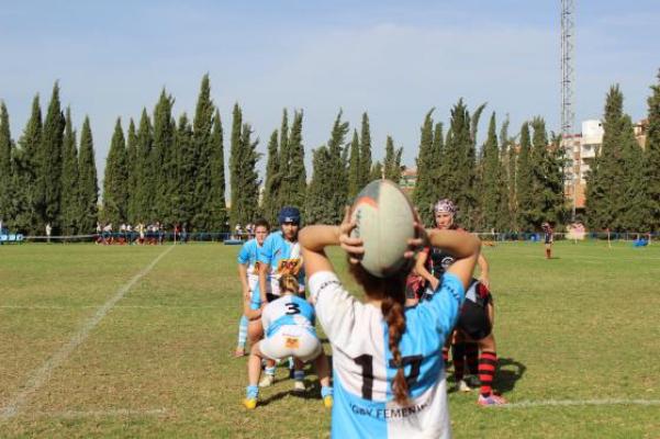 Una jugadora realiza un lanzamiento durante un partido de rugby femenino